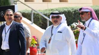 Salman bin Hamad Al Khalifa, the Crown Prince of Bahrain walks with three other men. | Mark Sutton/Motorsport Images/Si/Newscom