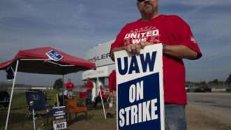 A man holding a sign that reads "UAW ON STRIKE" |  Sue Dorfman/ZUMAPRESS/Newscom
