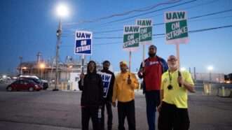 striking autoworkers holding signs | Mark Bialek/ZUMAPRESS/Newscom