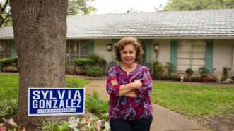 Sylvia Gonzalez stands in her front yard next to one of her city council campaign sign | Institute for Justice