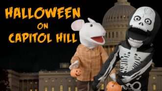 Two puppets in front of Capitol building fur Halloween | reasontv