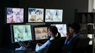 Security guards monitor a bank of CCTV security cameras. | Serezniy | Dreamstime.com