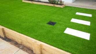 A raised bed filled with artificial grass. | Shuang Li | Dreamstime.com