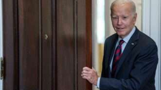 Biden and a door | Shawn Thew - Pool via CNP/ZUMA Press/Newscom