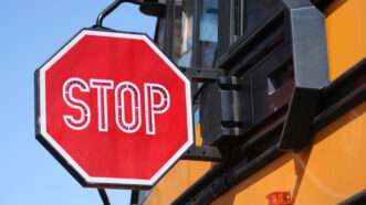 large stop sign on the side of a school bus | Joseph Mercier | Dreamstime.com