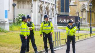 Police officers in the United Kingdom stand in a group. | Jiawangkun | Dreamstime.com