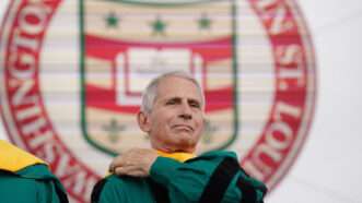 Retired Director of the National Institutes of Health Anthony Fauci adjusts his robe before receiving an honorary degree from Washington University. | BILL GREENBLATT/UPI/Newscom
