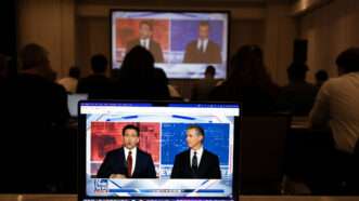 Florida Governor Ron DeSantis on screen debating California Governor Gavin Newsom | Robin Rayne/ZUMAPRESS/Newscom