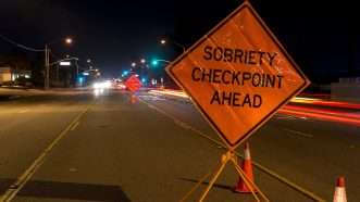 "Sobriety Checkpoint Ahead" sign indicating a DUi checkpoint. | John Roman | Dreamstime.com