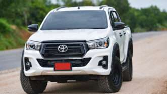 Toyota Hilux truck on a dirt road. | Engdao Wichitpunya | Dreamstime.com