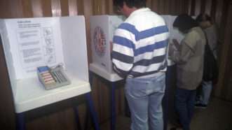 Men and women vote at a polling station. | Joe Sohm | Dreamstime.com