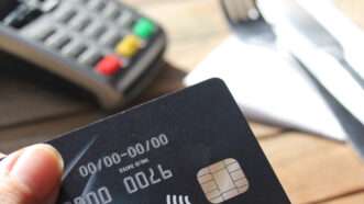 Close-up of a credit card about to be used at point of sale. | Lorna Jane | Dreamstime.com
