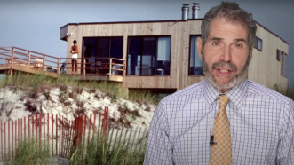John Stossel is seen in front of a beach house | Stossel TV