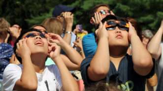 Kids with glasses stare at solar eclipse | Mira Agron | Dreamstime.com