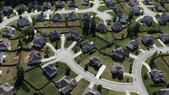 Aerial view of suburban neighborhood homes | trekandshoot/Dreamstime.com
