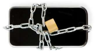 A smartphone chained up with a lock | Photo: Eshma/iStock