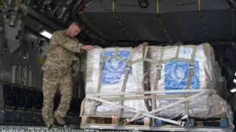 An Air Force member offloading packages from an aircraft | U.S. Air Force photo by Staff Sgt. Daniel Hernandez