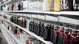 Jars of food sit on rows of shelves, as if preparing for hard times. | Glenda Powers | Dreamstime.com