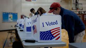 Voters standing at voting booths | Michael Nigro/Sipa USA/Newscom