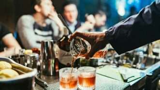 Bartender pouring alcoholic beverages for customers | Photo by Stanislav Ivanitskiy on Unsplash