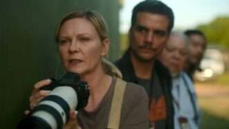 A still from the movie "Civil War" of Kirsten Dunst holding a camera | A24/Civil War