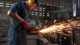 A man works in manufacturing at a factory | Photo 161332327 © Omar Osman | Dreamstime.com