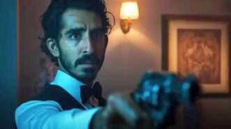 Dev Patel's character in 'Monkey Man' pointing a gun at the camera | Bron/Thunder Road/Monkey's Paw