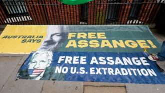 Signs on the sidewalk outside the Ecuadorian embassy in London that say FREE ASSANGE and NO U.S. EXTRADITION. | Martyn Wheatley/i-Images / Polaris/Newscom