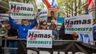 Multiple protesters hold signs that say "Hamas are terrorists" in London. | Tayfun Salci/ZUMAPRESS/Newscom