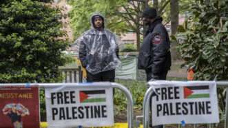 Two security guards stand near "Free Palestine" signs as a protest | Probal Rashid/ZUMAPRESS/Newscom