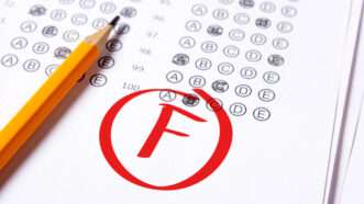 A test paper with questions filled out, a pencil sitting on the page, and a big red 'F' with a circle around it | Photo 130245786 | School © Dragan Andrii | Dreamstime.com