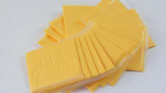 A fanned-out stack of American cheese slices, individually packaged. | Dorothy Merrimon Crawford | Dreamstime.com
