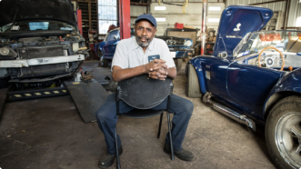 Hinga Mbogo is seen in his auto repair shop | Institute for Justice
