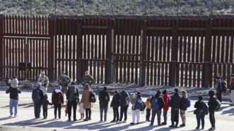 Chinese migrants stand in front of Border Patrol agents at the U.S.-Mexico border | Kyodonews/ZUMAPRESS/Newscom