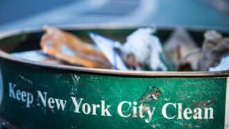 Green trash can that says, "Keep New York City Clean." | Photo 58512828 © Daniel Kaesler | Dreamstime.com