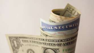 A Social Security card is seen wrapped in money | Photo 42010295 © Peterfactors | Dreamstime.com
