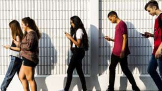 Teenagers looking at phones | Photo 113110344 © Rawpixelimages | Dreamstime.com