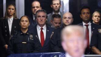 A photo of Donald Trump with Doug Burgum, Vivek Ramaswamy, and others watching in the background | Photo: Michael M. Santiago/UPI/Newscom
