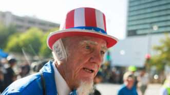 A man dressed like Uncle Sam with gauze on his ear to imitate Donald Trump | Photo: Jeremy Hogan/SOPA Images/LightRocket/Getty Images