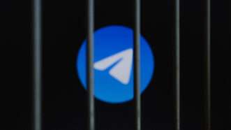 Telegram Messenger logo is displayed on a screen behind bars. | Andre M. Chang/ZUMAPRESS/Newscom