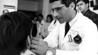 Anthony Fauci examining a patient | Photo: Anthony Fauci examining an early AIDS patient at the NIH, 1987; American Photo Archive/Alamy