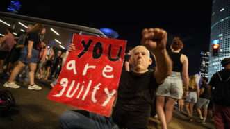 Protestor wearing mask of Benjamin Netanyahu | Pavel Nemecek/ZUMA Press/Newscom