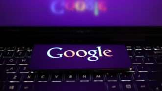 Google logo on smartphone resting on computer keyboard | Alvin Chan/ZUMAPRESS/Newscom