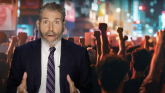 John Stossel is seen in front of a protest | Stossel TV