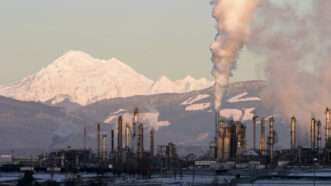 Factory smokestack billowing in front of mountain range | ID 1942436 © Matthew Ragen | Dreamstime.com