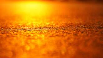 The orange glare of the sun against hot asphalt, in close-up. | Kirill Karpov | Dreamstime.com