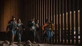 Migrants walk along the U.S.-Mexico border in Yuma, Arizona | weizhong qian/Qian Weizhong/VCG/Newscom