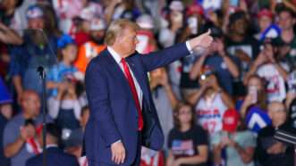 Trump speaks to a crowd of people seated on risers | : Josh Brown/ZUMAPRESS/Newscom