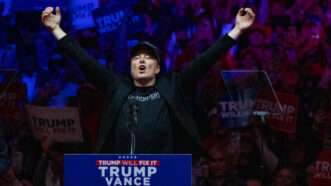 Elon Musk, who has been tapped to head the Department of Government Efficiency, raises his hands in celebration at a Trump rally. | Jen Golbeck/ZUMAPRESS/Newscom