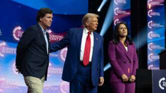 Donald Trump greets Tucker Carlson and Tulsi Gabbard at a rally in Duluth, Georgia. October 23, 2024. | Robin Rayne/ZUMAPRESS/Newscom